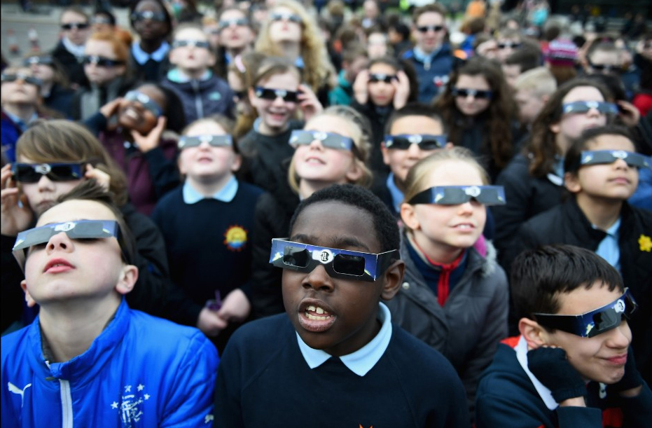Kids watching a solar eclipse